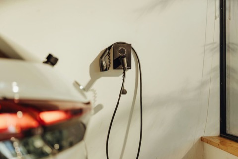 Borne de recharge installée devant une habitation.